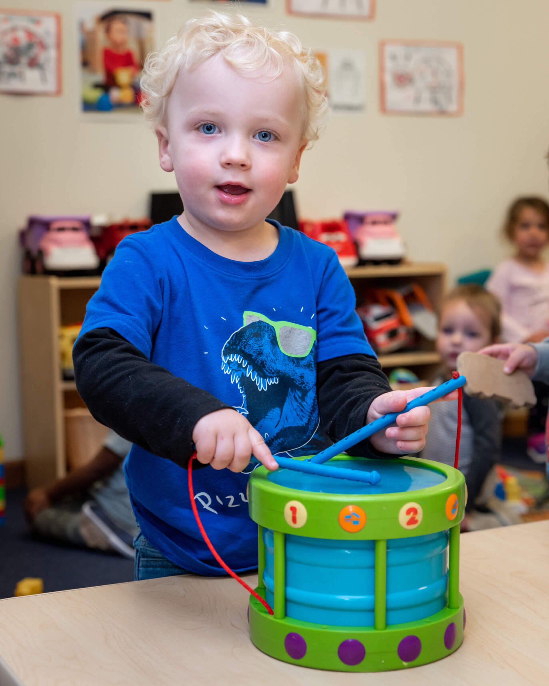 Toddler Playing with Toy Drums