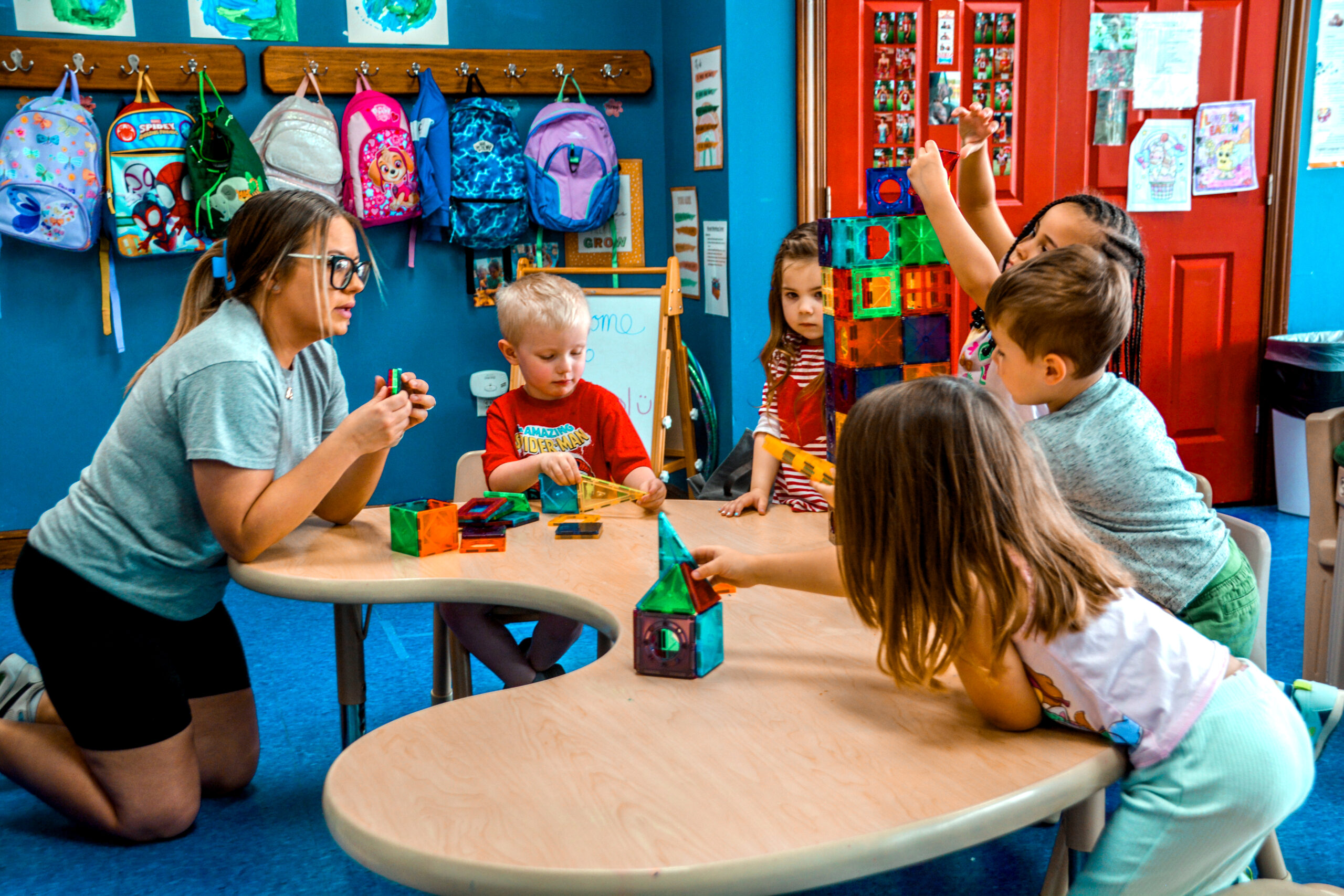 Children at ChildScape Learn & Grow playing blocks with their teacher