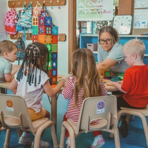 teacher playing blocks with preschoolers at ChildScape in North Canton