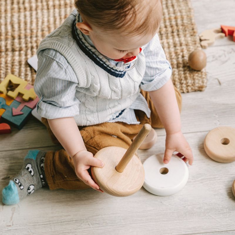 infant playing with toys