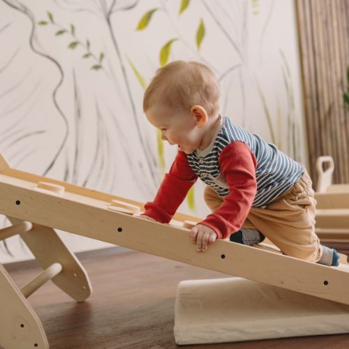 toddler playing on slide