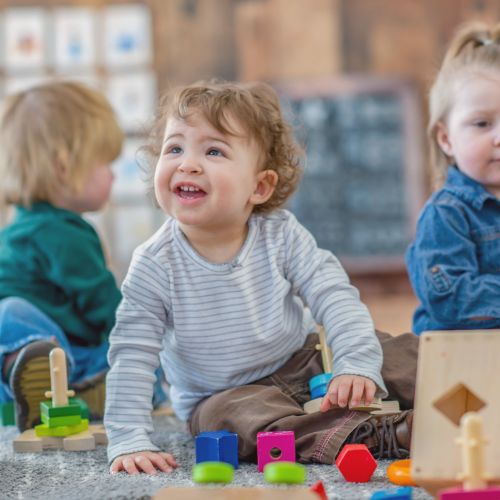 toddlers playing with blocks